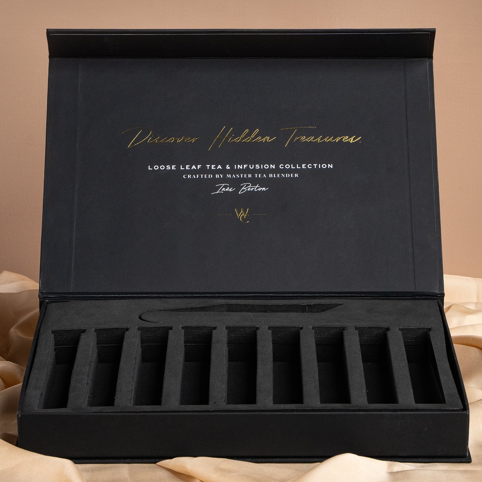Custom rigid box featuring a die-cut insert with an inner gold foiled flip-top lid displayed on a grey background
